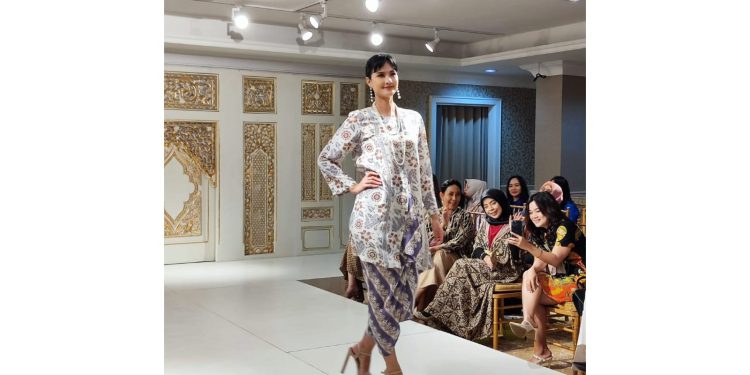 Seorang model dengan busana batik bermotif bunga sebagai inspirasi pilihan busana di saat lebaran nanti.